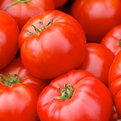 Red beefsteak tomatoes stacked together